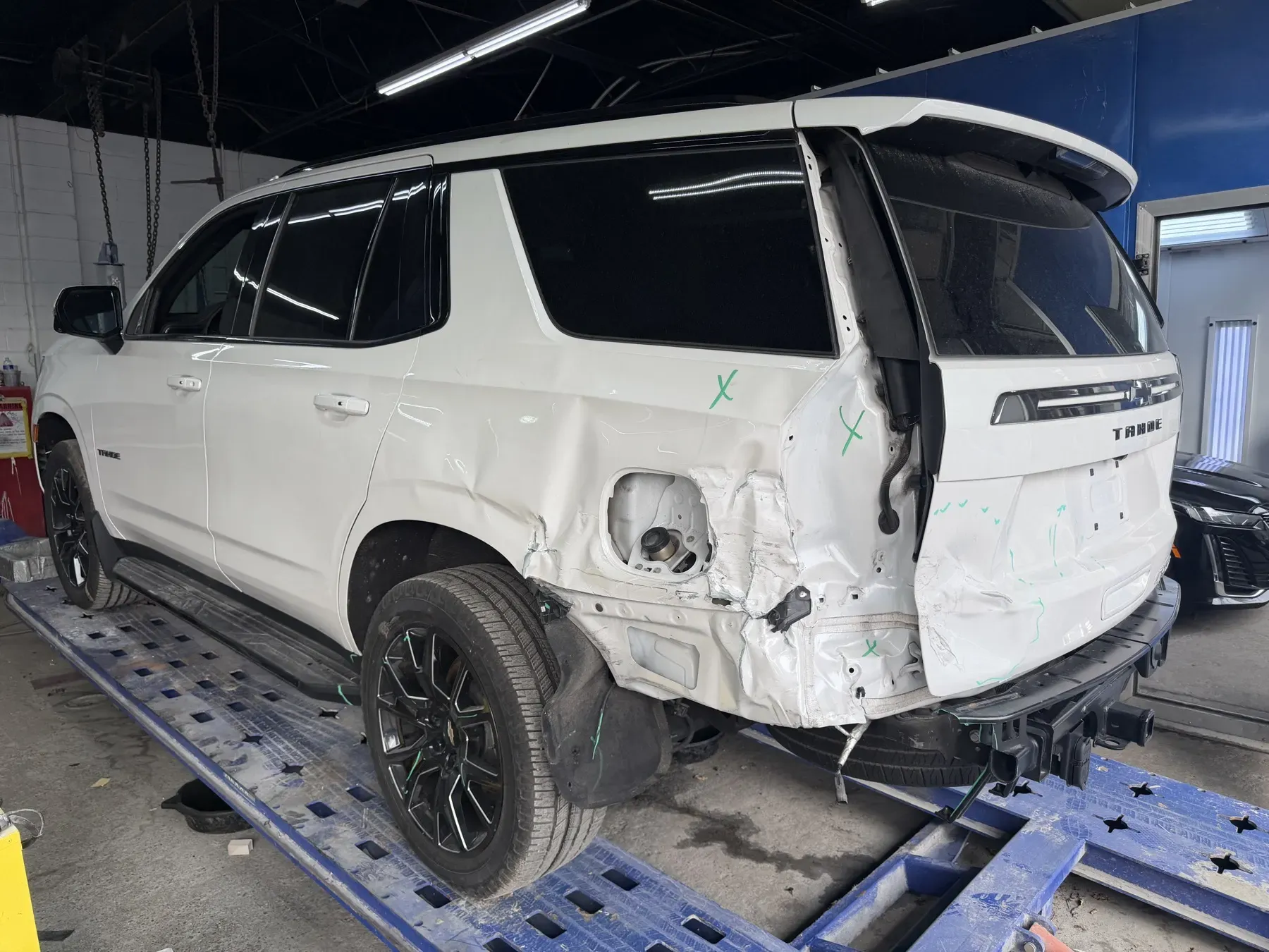 Chevy Tahoe: Rear quarter damage on the frame machine.